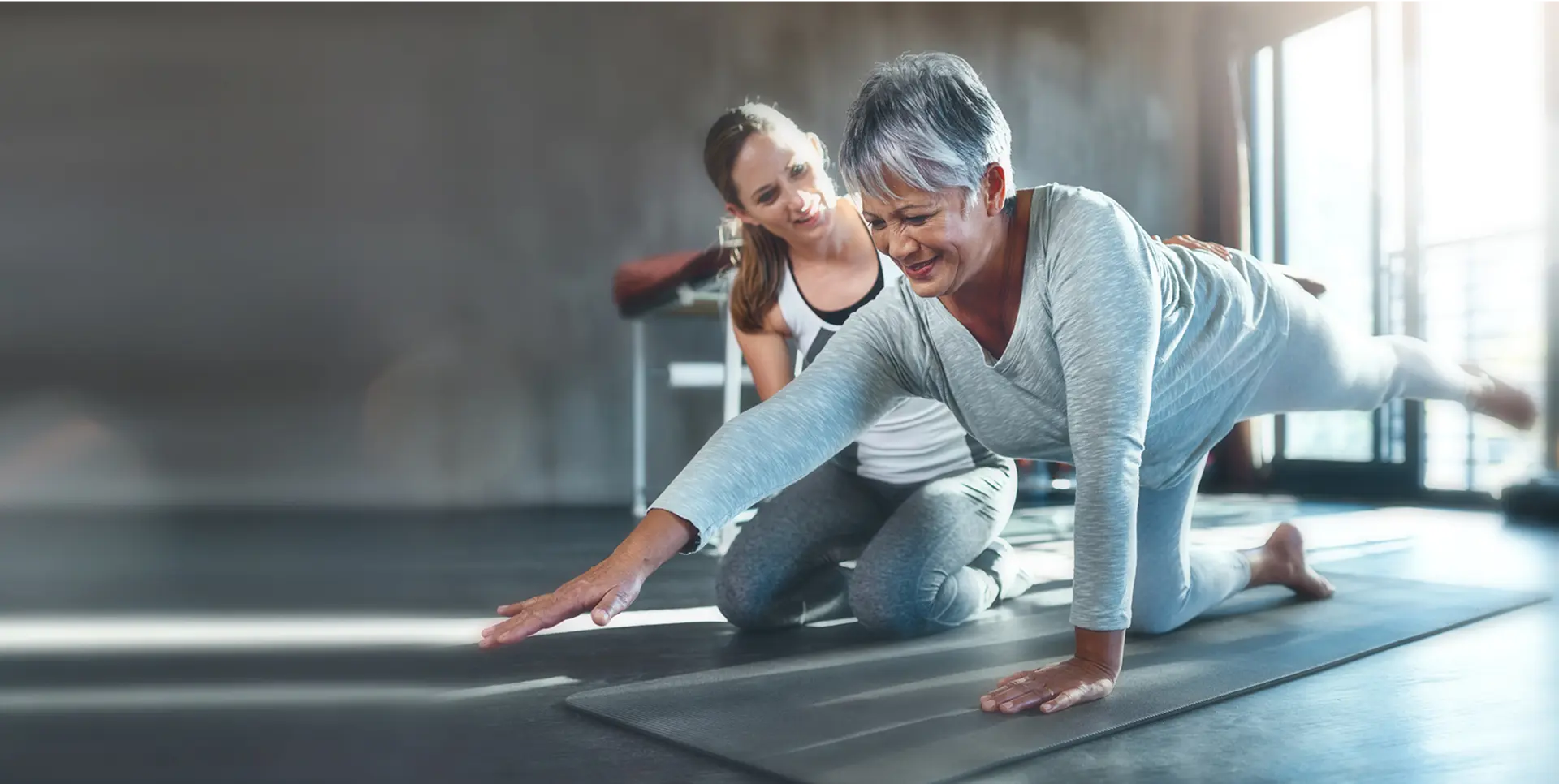 Woman practicing yoga with instructor guidance