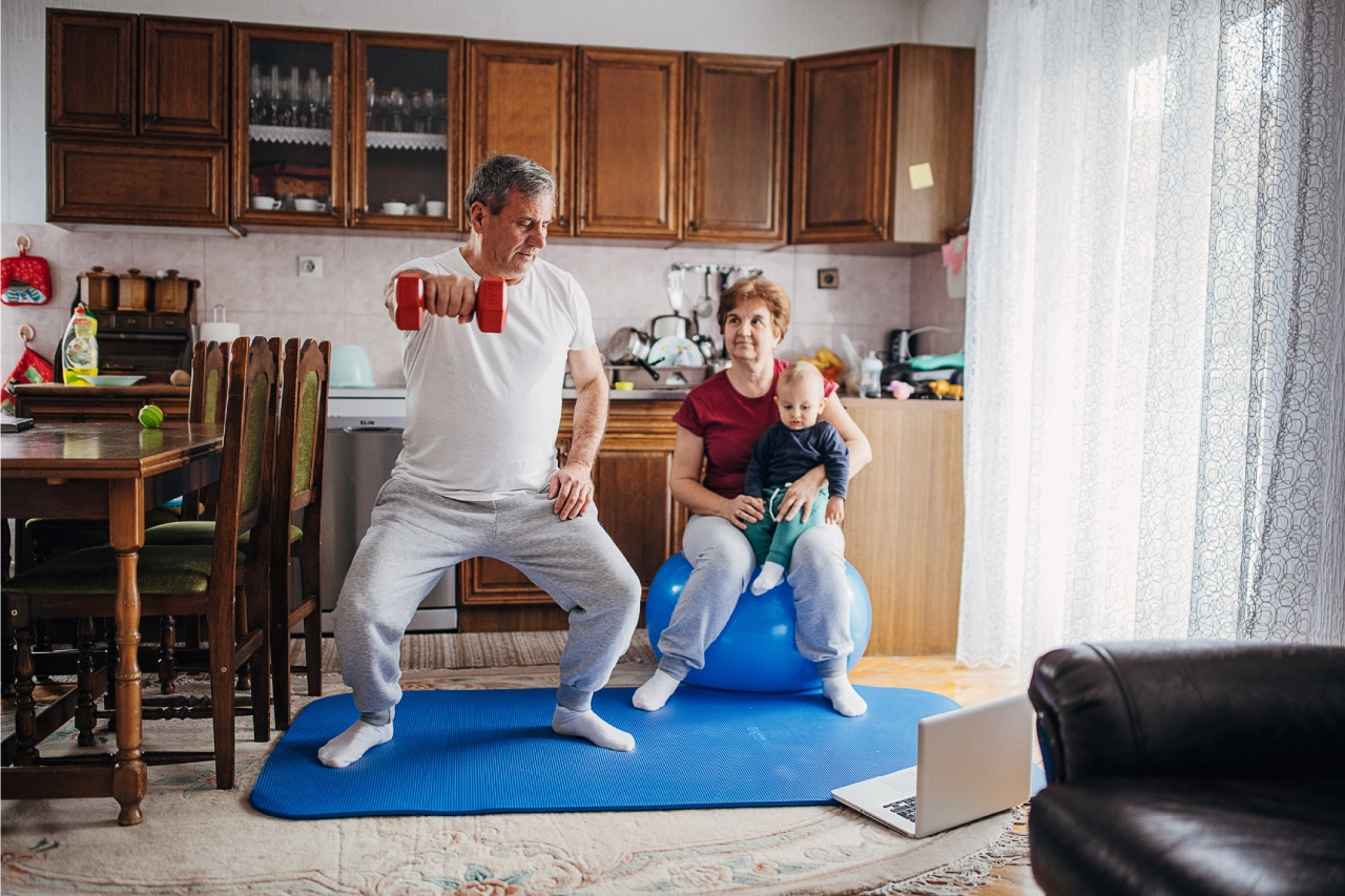 Man exercising with dumbbells at home